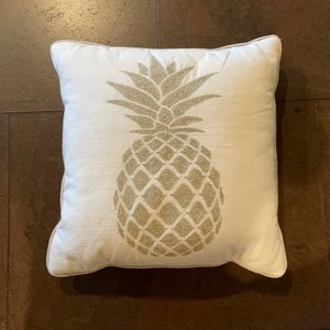 White pillow with golden pineapple